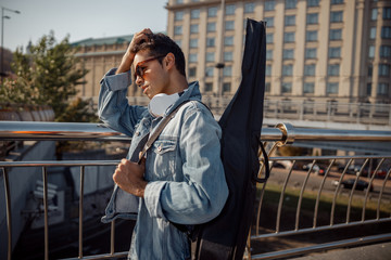 Young musician is straightening hair by hand