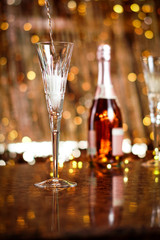 Champagne flute glasses celebration scene with lights and bokeh balls