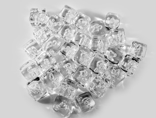 Many ice cubes isolated on a neutral background.