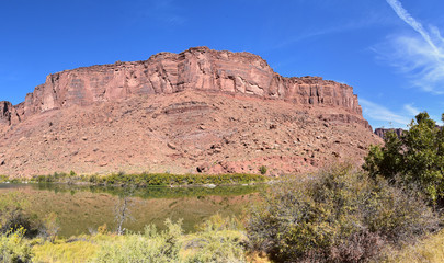Fototapeta premium Moab Panorama views of Colorado River Highway UT 128 in Utah around Hal and Jackass canyon and Red Cliffs Lodge on a Sunny morning in fall. Scenic nature near Canyonlands and Arches National Park, 