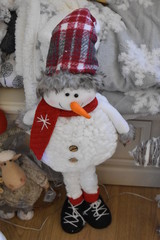 Cute fluffy smiling snowman toy with red hat and scarf. Christmas decoration becomes available to buy in stores in the UK end of September. Festive ornaments are available to purchase online all year 