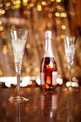 Champagne flute glasses celebration scene with lights and bokeh balls