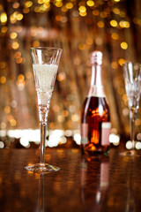 Champagne flute glasses celebration scene with lights and bokeh balls