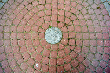 Circle pattern cobble stone, street pavement. Ancient cobblestone paved circle