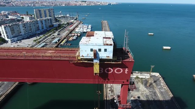 abandoned dock crane shipyard almada portugal aerial shot 4k