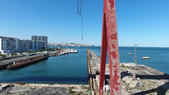 abandoned dock crane shipyard almada portugal aerial shot 4k