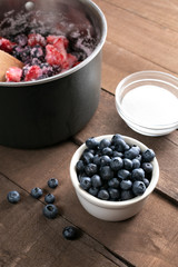 Ramekin of blueberries and sugar, in a pie recipe scene 