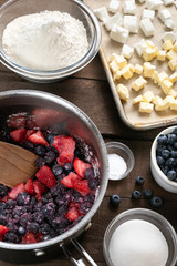 Berry pie ingredients on a rustic wood table