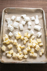butter and shortening cubes on a baking sheet, in baking background