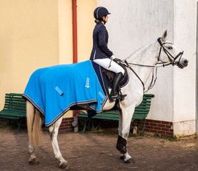 Horse riding . Young girl riding a horse . Equestrian sport in details.