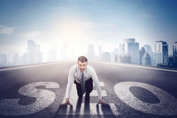 Businessman crouching and preparing to run