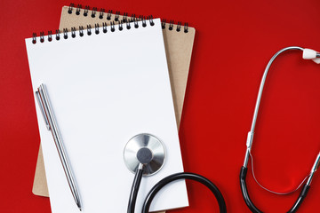 Stethoscope on a red table, concept medicine