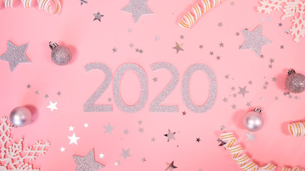 2020 Christmas and new year background banner with the beautiful decor gift for holiday in winter. On bright pink, golden and silver color theme with snow flake. top view with copy space.