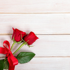 Valentine background of  red roses on  white wood
