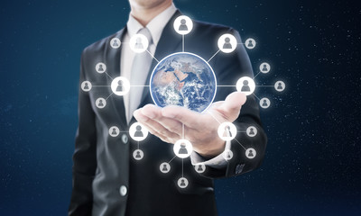 Global networking and global business network. Businessman holding globe with social networking icons. Element of this image are furnished by NASA