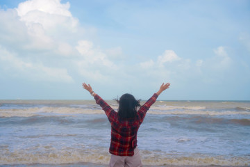 Obraz premium Woman rise hands up to sky freedom concept with blue sky.