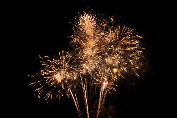 Gold fireworks on black background for winter and new year festivals.