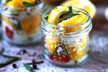 Fermented lemons with salt and spices. Salted pickled lemons. Probiotics and fermented foods. Selective focus. Macro.