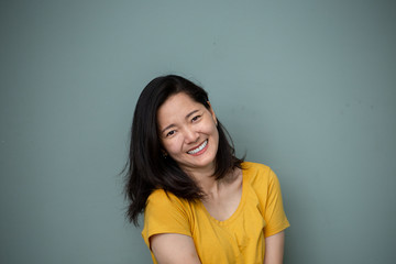 Fototapeta premium portrait happy cheerful young brunette asian woman with perfect smilling,clean skin.beautiful girl posing show white teeth smile relaxing.fashion people freedom life style concept