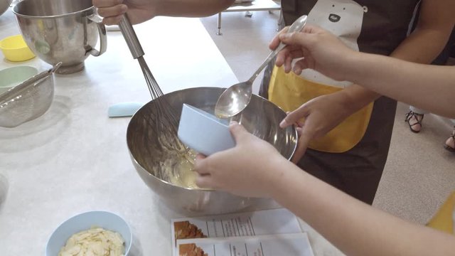 Whicking cake batter by hand in a mixing bowl