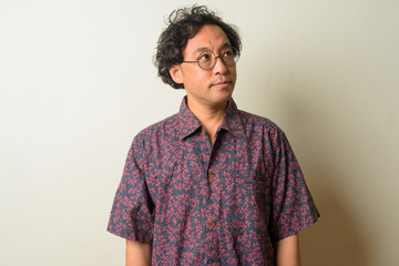 Portrait of Japanese man with curly hair thinking