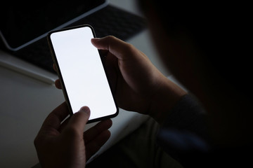 Cropped shot view of man hands holding smart phone with blank copy space screen for your text message or information content, female reading text message on cell telephone during in urban setting. 