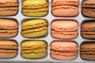 assortment of multi-colored french macaroons, delicious sweets. Background, top view