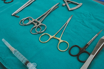 Fototapeta na wymiar Set of surgical instruments on a blue background.