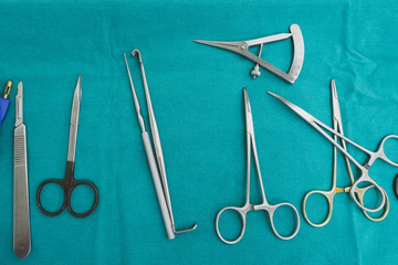 Set of surgical instruments on a blue background.