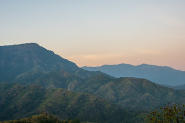 beautiful blue sky high peak mountains mist fog wildlife green forest at Khao Koh, Phu Tub Berk, Phetchabun, Thailand  guiding idea long weekend for backpacker camping campfire relaxing hiking