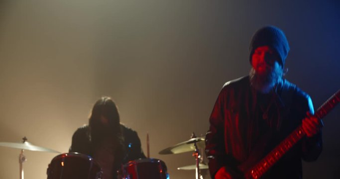 Rock duet performing. Professional guitarist and drummer rocking the party up in club, playing coll rock, punk or metal music 4k footage
