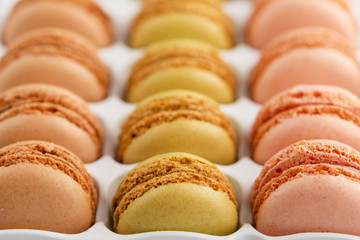 background with an assortment of colored french sweets macaroon, selling a shop or cafeteria, restaurant. Tastes and sweets