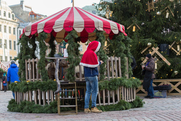 Fototapeta na wymiar City Riga, Latvia. Christmas market with peoples and little street markets.