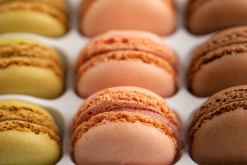 background with an assortment of colored french sweets macaroon, selling a shop or cafeteria, restaurant. Tastes and sweets