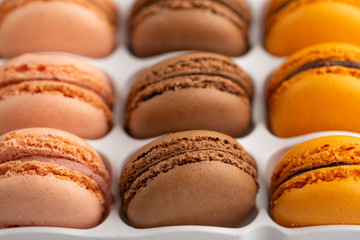 background with an assortment of colored french sweets macaroon, selling a shop or cafeteria, restaurant. Tastes and sweets