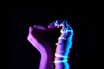 Heart shaped by human and robot hands. Isolated on black background.