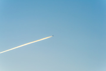 Jet plane flying through clouds at high altitude. 