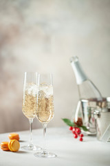 Two glasses of  champagne on light background. Festive drink. Valentins or Christmas concept.