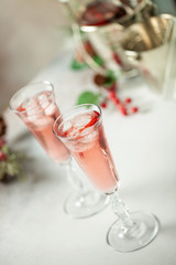 Two glasses of  champagne on light background. Festive drink. Valentins or Christmas concept.