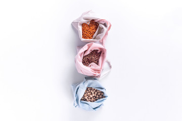 Groceries in eco bags. Natural cotton bags with cereal, eco friendly. Sustainable lifestyle concept. Zero waste food shopping. Plastic free items. Reuse, reduce, recycle, refuse