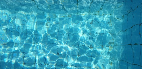 shiny blue water in swimming pool wallpaper background 