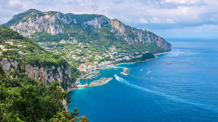 Fototapeta na wymiar The north side of the beautiful resort island of Capri, with its steep limestone cliffs and azure water.