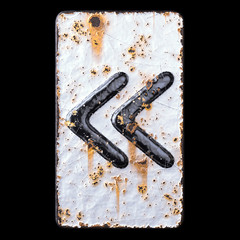 Symbol left pointing double angle quotation mark made of forged metal on the background fragment of a metal surface with cracked rust.