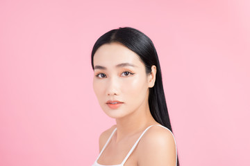 Portrait of young Asian woman with perfect skin on pink background. Concept of natural cosmetics and skincare.