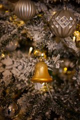 Christmas tree decorated with toys in traditional  gold color, luminous Christmas garland