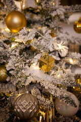 Christmas tree decorated with toys in traditional  gold color, luminous Christmas garland