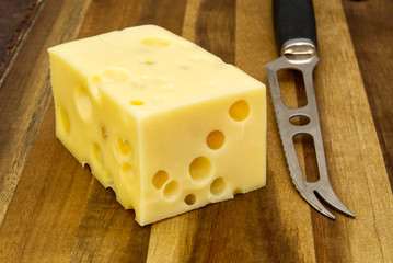 Piece of cheese close-up. cheese on a wooden board