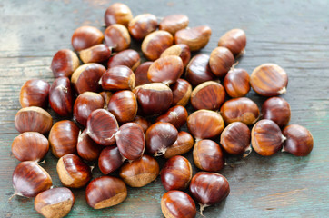 Edible chestnuts on the  wooden table.