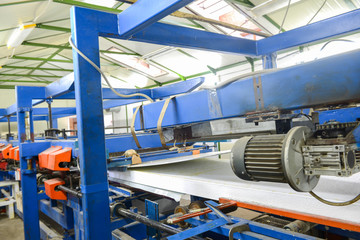 Fototapeta premium Press machine glues panel. Plant for the production of sandwich panels from styrofoam