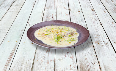 Baked turkey breast with white sauce and greenery.